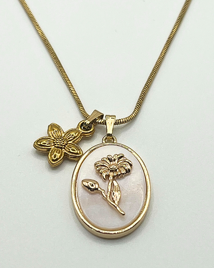 Goudkleurige ketting met ovalen hanger en bloembedel